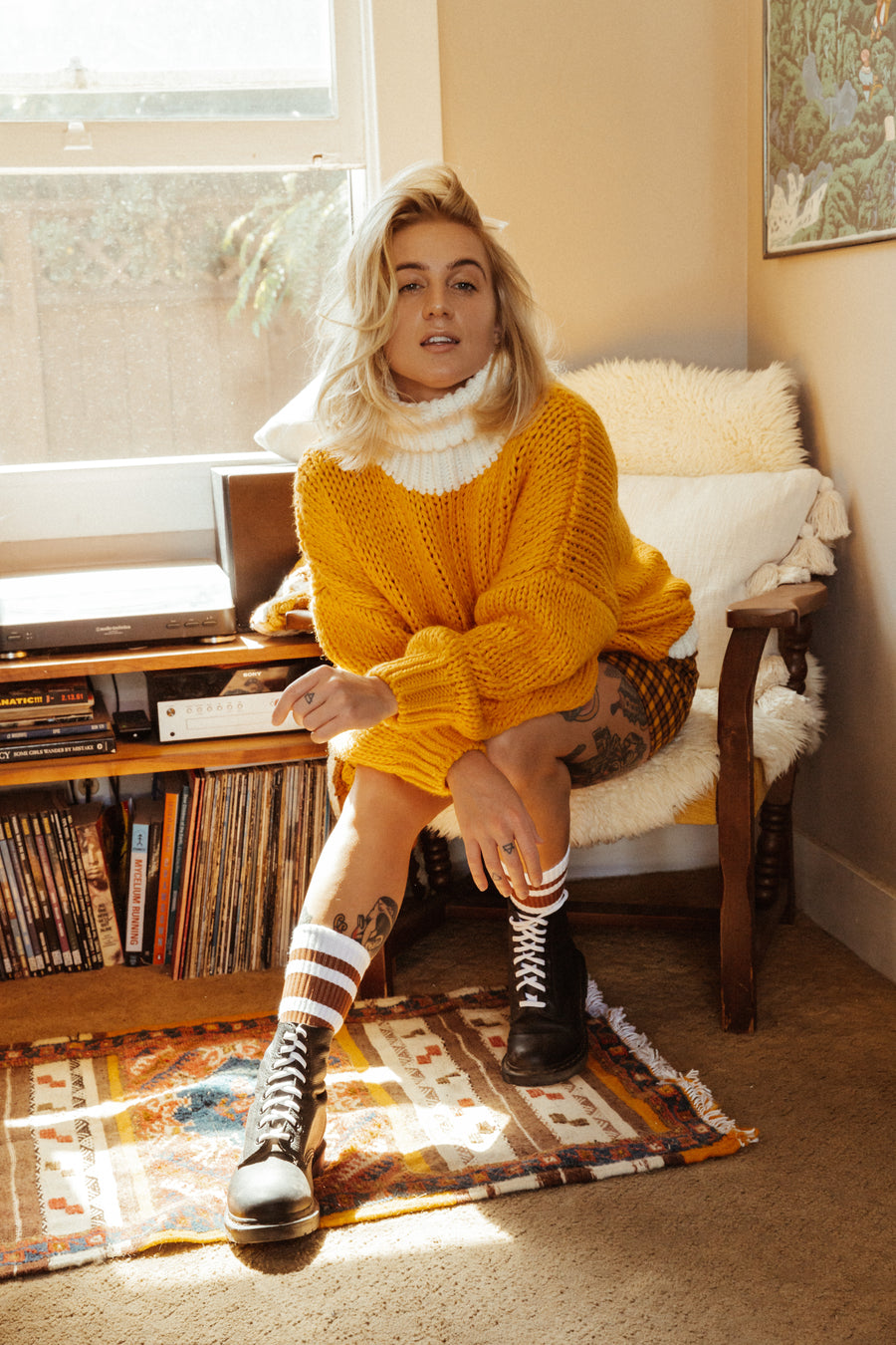 Blonde female wearing brown striped SOCCO socks with Doc Martens Boots