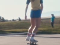 Female skateboarding wearing red and black stripes SOCCO socks