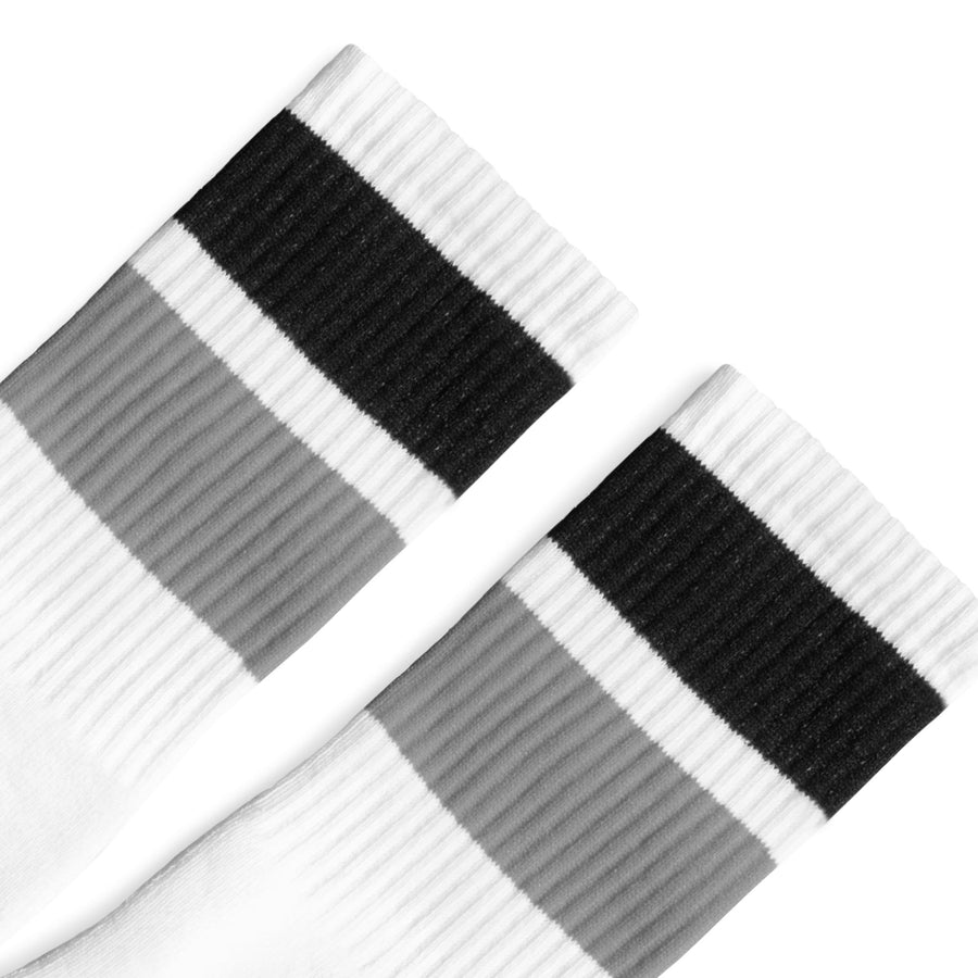 White athletic socks with two bold stripes on the leg, one Black and one Grey. For men, women and kids. Crew Sock Length.