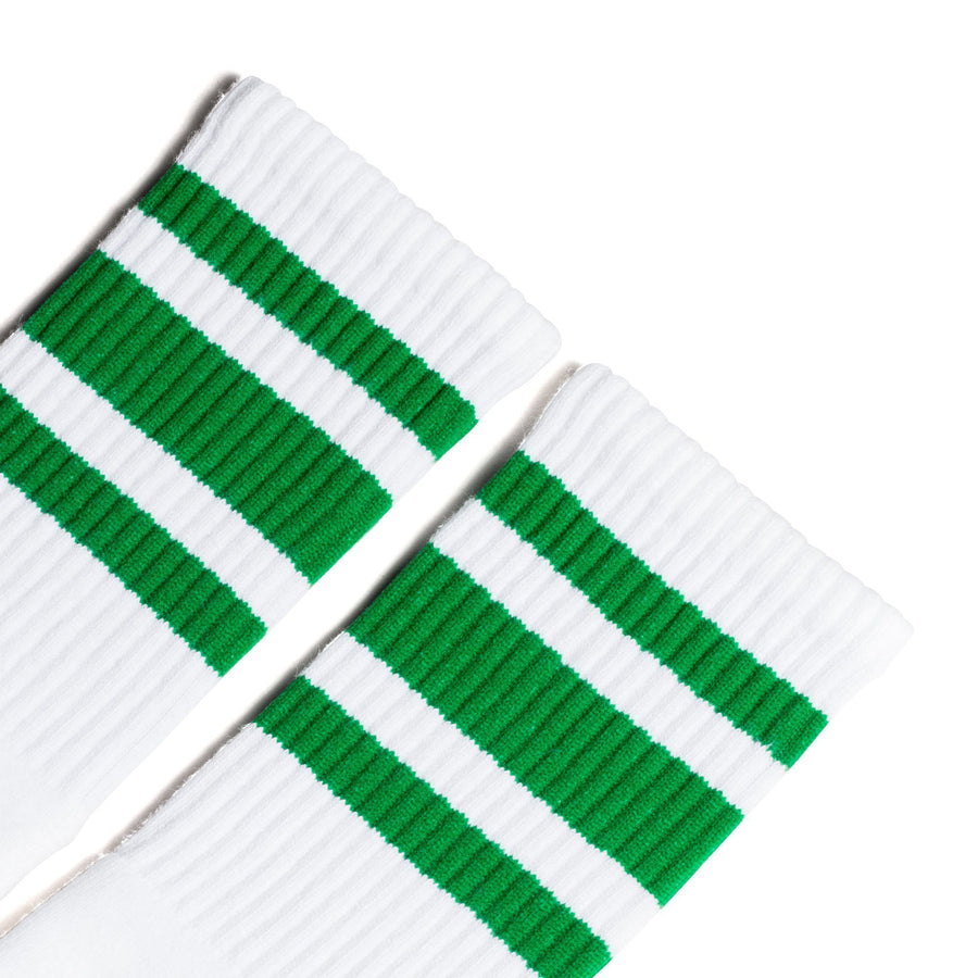 White athletic crew length socks with three green stripes for men, women and children.