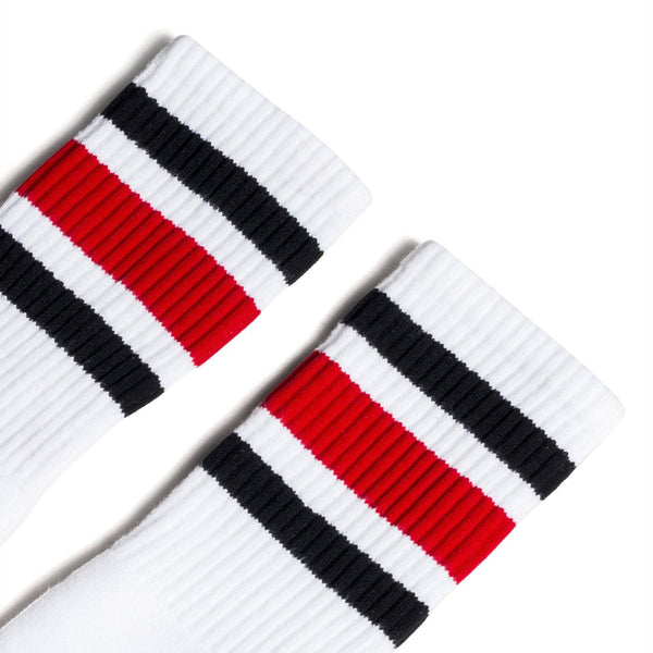 White athletic socks with black and red stripes on the leg. Made for men, women and children. Crew Sock Length.