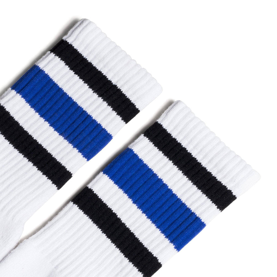 White athletic socks with black and blue stripes on the leg. Made for men, women and children. Crew Sock Length.