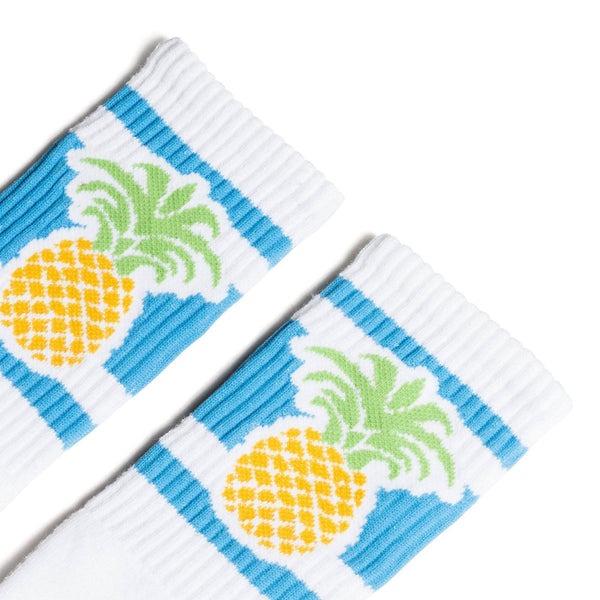 White socks with blue stripes and a pineapple image for men, women and kids.