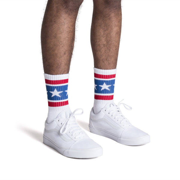 White athletic socks with two red stripes and white stars on a thick blue stripe for men, women and kids.