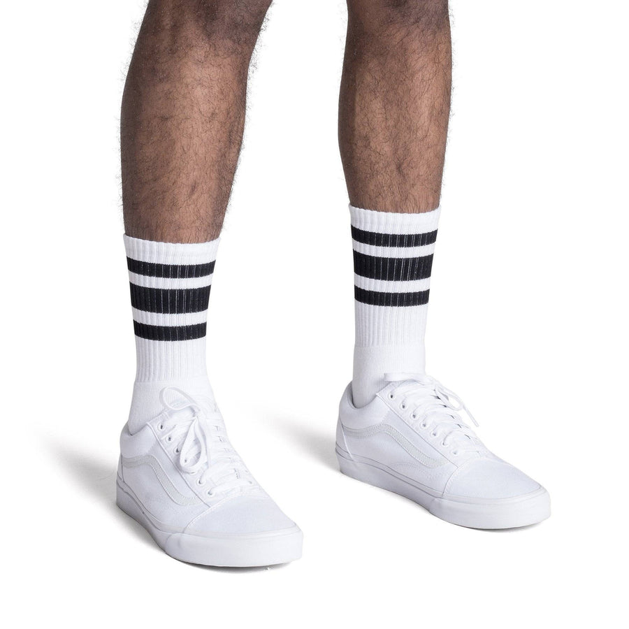 White athletic socks with three black stripes on the Leg. For men, women and kids. Crew Sock Length.