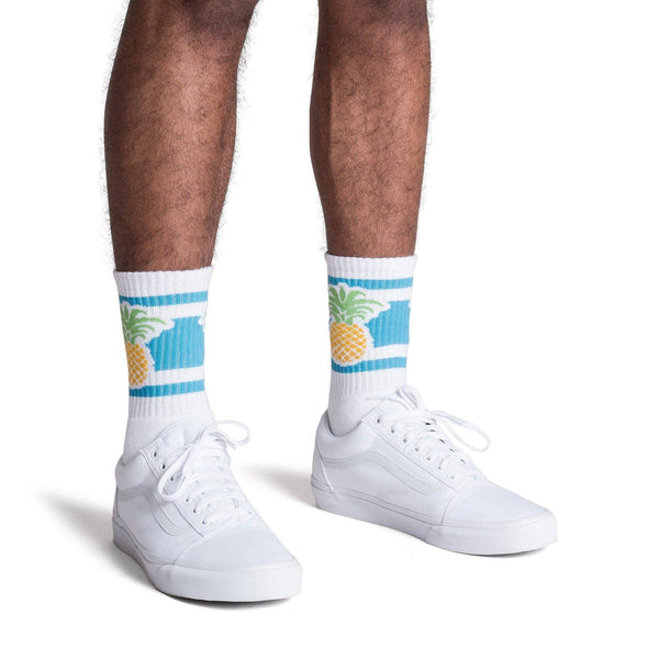 White socks with blue stripes and a pineapple image for men, women and kids.