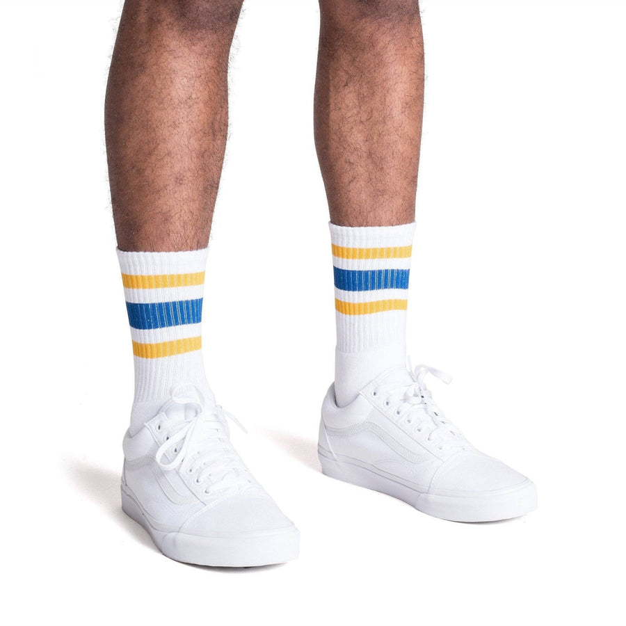 White athletic Crew Length socks with gold and blue stripes for men, women and children.