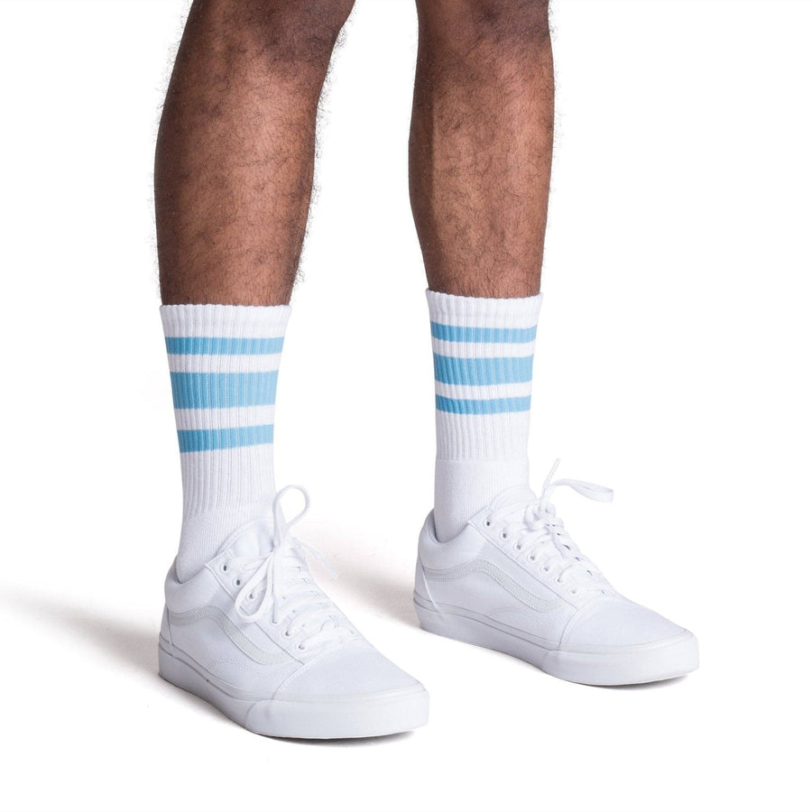 White athletic socks with three Carolina blue stripes. Crew Length Socks for men, women and kids.