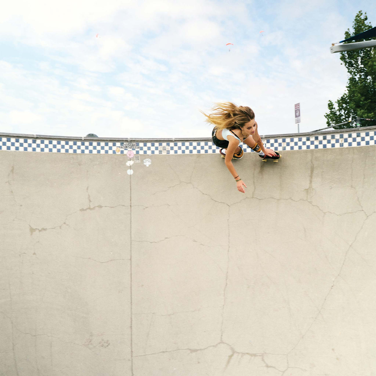 Roller skater Olivia Wardlow skating at the coping of a pool in her signature SOCCO socks.