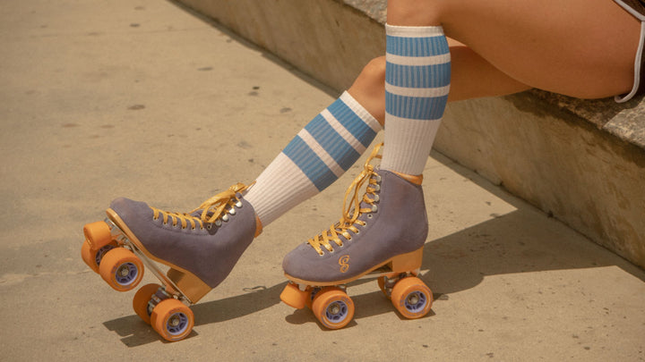 Female wearing true knee high socks from SOCCO with her roller skates.