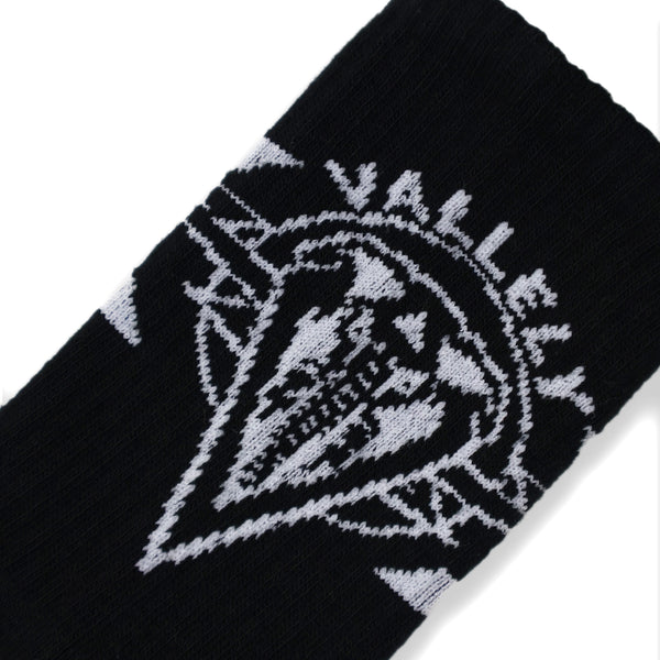 Dirty Donny x Mike Vallely Collaboration Crew Socks. Black Crew Socks with 3 white stripes on the leg. Mike Vallely's Elephant V Logo with lightning bolts in an inverted triangle on the front of the leg. "VALELLY" in all caps above the Mike V Elephant Logo.