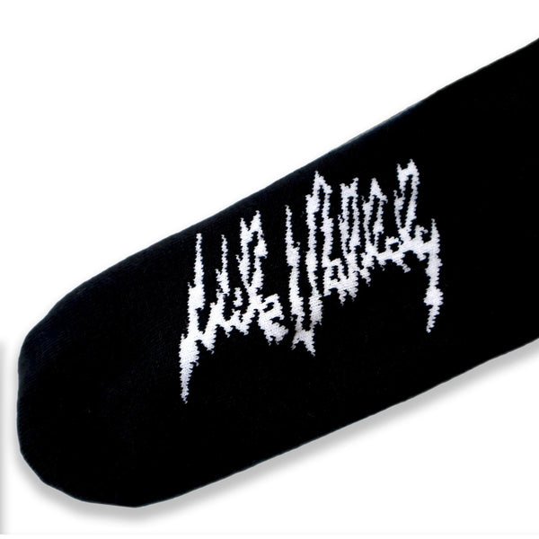 Dirty Donny x Mike Vallely Collaboration Crew Socks. Black Crew Socks with 3 white stripes on the leg. Mike Vallely's Elephant V Logo with lightning bolts in an inverted triangle on the front of the leg. "VALELLY" in all caps above the Mike V Elephant Logo.