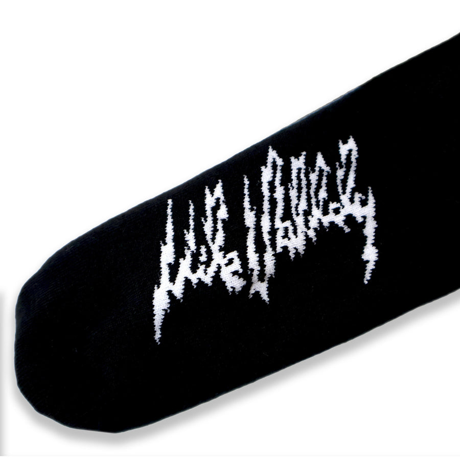 Dirty Donny x Mike Vallely Collaboration Crew Socks. Black Crew Socks with 3 white stripes on the leg. Mike Vallely's Elephant V Logo with lightning bolts in an inverted triangle on the front of the leg. 