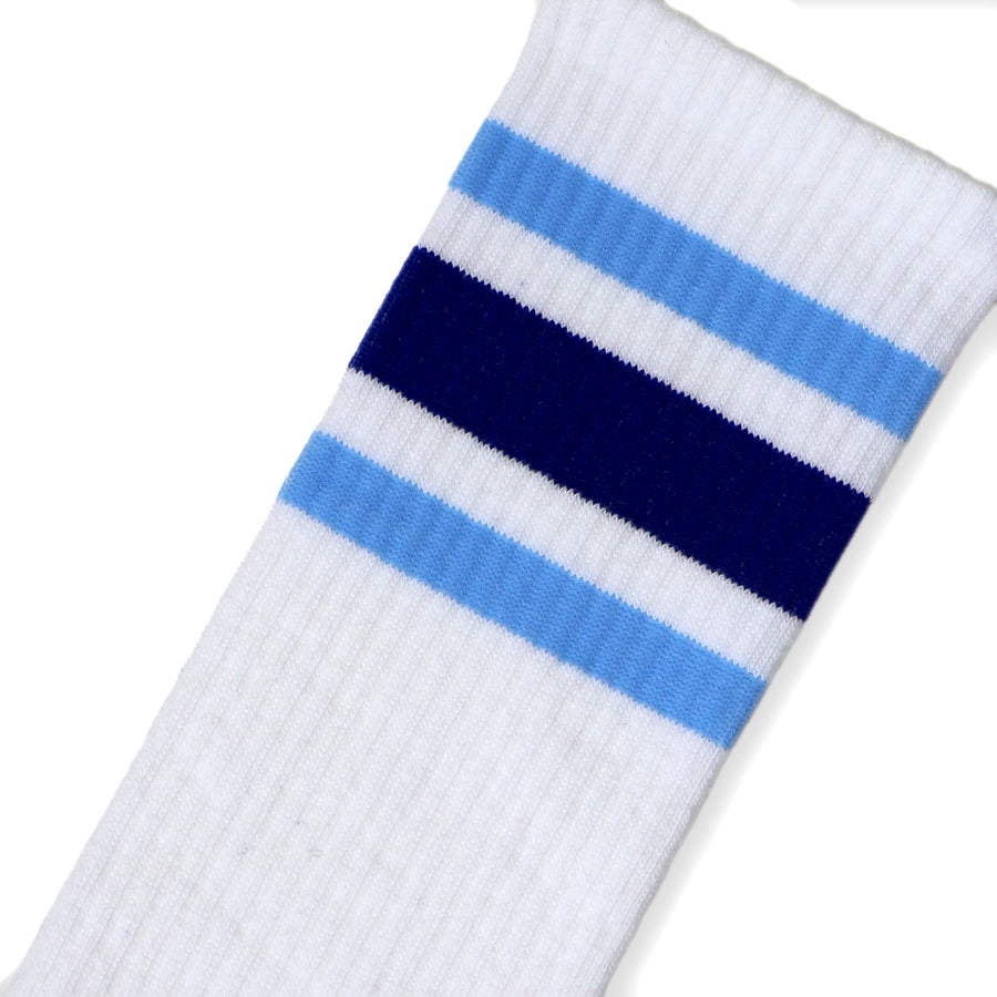 A Close-Up, Angled Photo of a Light Blue, Dark Blue, & Light blue set of 3 stripes on White Classic Knee High Length Socks.
