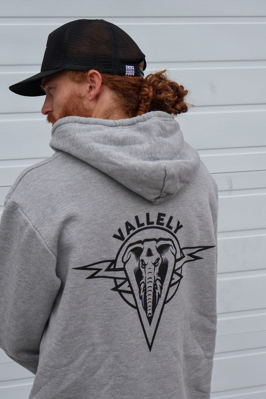 Heather Gray Dirty Donny x Mike Vallely Collaboration Logo Hoodie with White Pull Strings and Black logo on the front left chest area. Close up of Large Black Logo on the back of the Hoodie.
