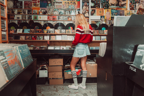 Female wearing grey with black checker SOCCO socks.