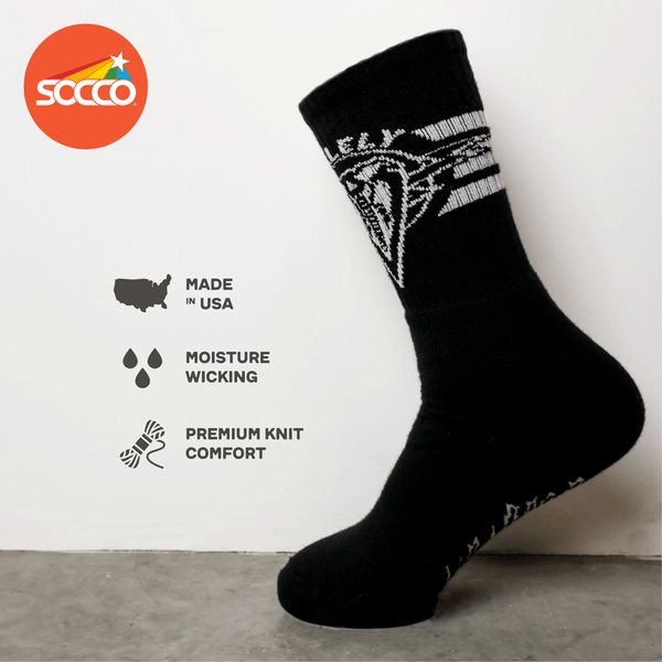 Dirty Donny x Mike Vallely Collaboration Crew Socks. Black Crew Socks with 3 white stripes on the leg. Mike Vallely's Elephant V Logo with lightning bolts in an inverted triangle on the front of the leg. "VALELLY" in all caps above the Mike V Elephant Logo.