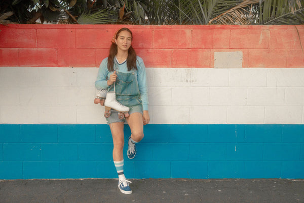 Female wearing ocean shades SOCCO socks with shades of blue