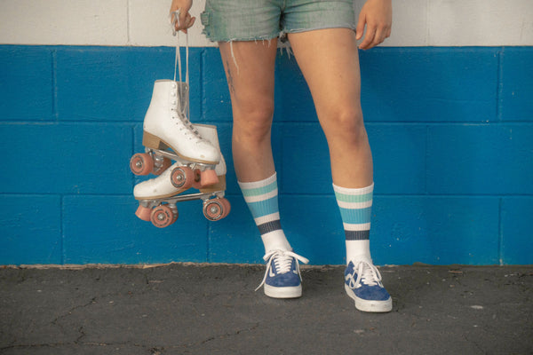 Female wearing ocean shades SOCCO socks with shades of blue