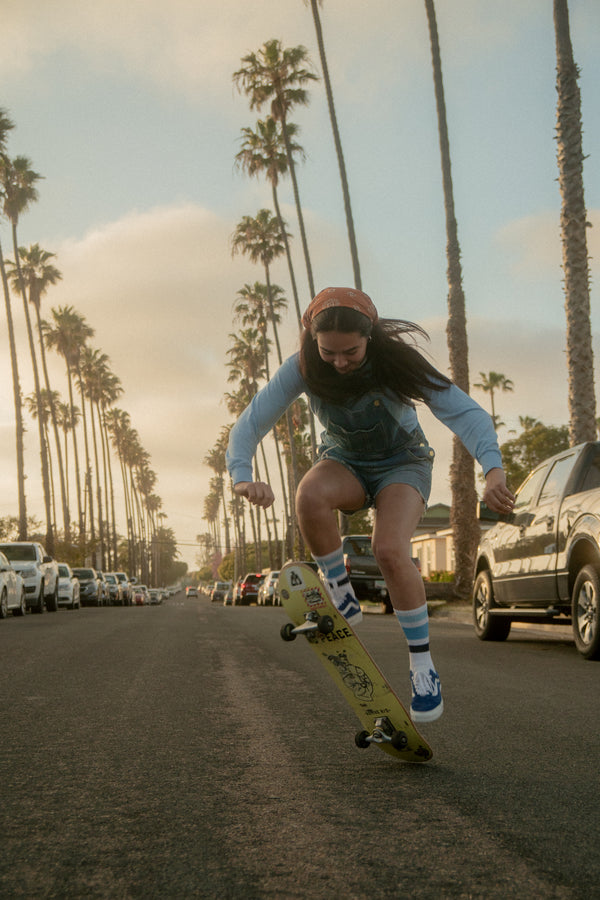 Female wearing ocean shades SOCCO socks with shades of blue