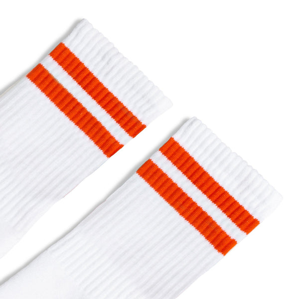 a pair of white socks with orange stripes