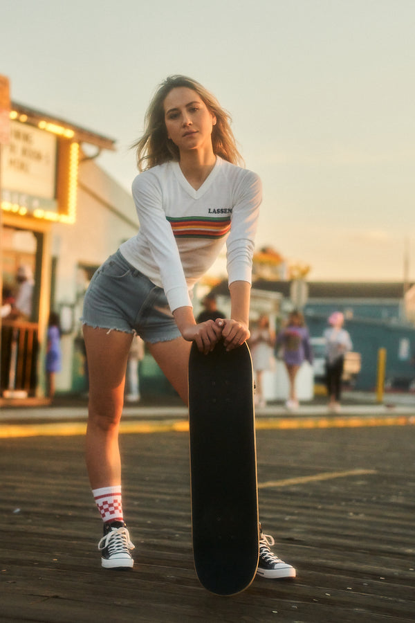 Female skateboarder wearing red checkered SOCCO socks.