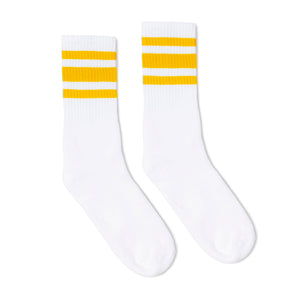 White athletic crew length socks with three gold stripes for men, women and children.