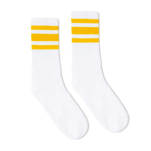 White athletic crew length socks with three gold stripes for men, women and children.