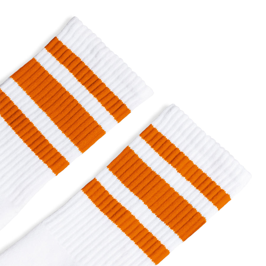 White athletic socks with three orange stripes for men, women and kids.