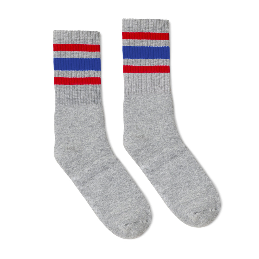 Grey athletic tube socks with red and blue stripes. Gray color.