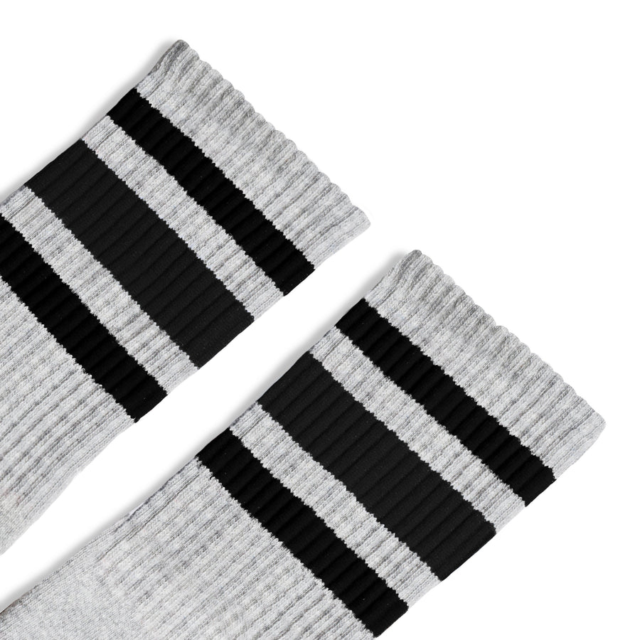 Grey athletic socks with black stripes for men, women and children.