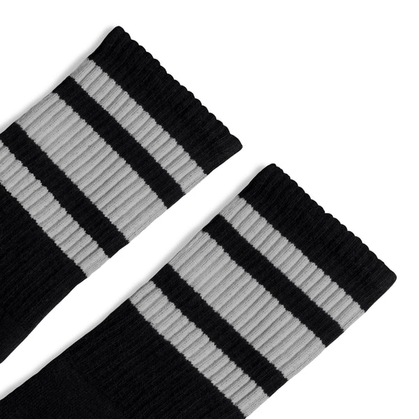 Black athletic crew length socks with three grey stripes for men, women and children.