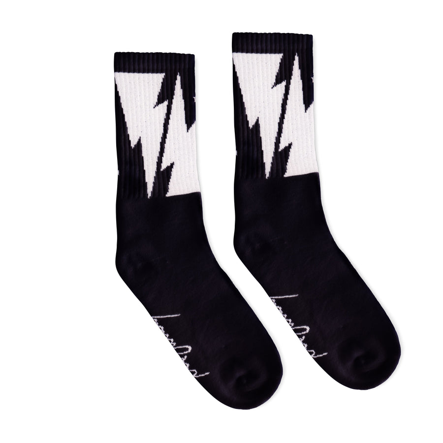 Black Crew socks with Large White Lightning Bolts decorating the leg all the way around. Mike Vallely's Signature knitted into the bottom of the foot.