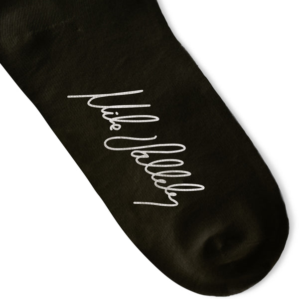 Black Crew socks with Large White Lightning Bolts decorating the leg all the way around. Mike Vallely's Signature knitted into the bottom of the foot.