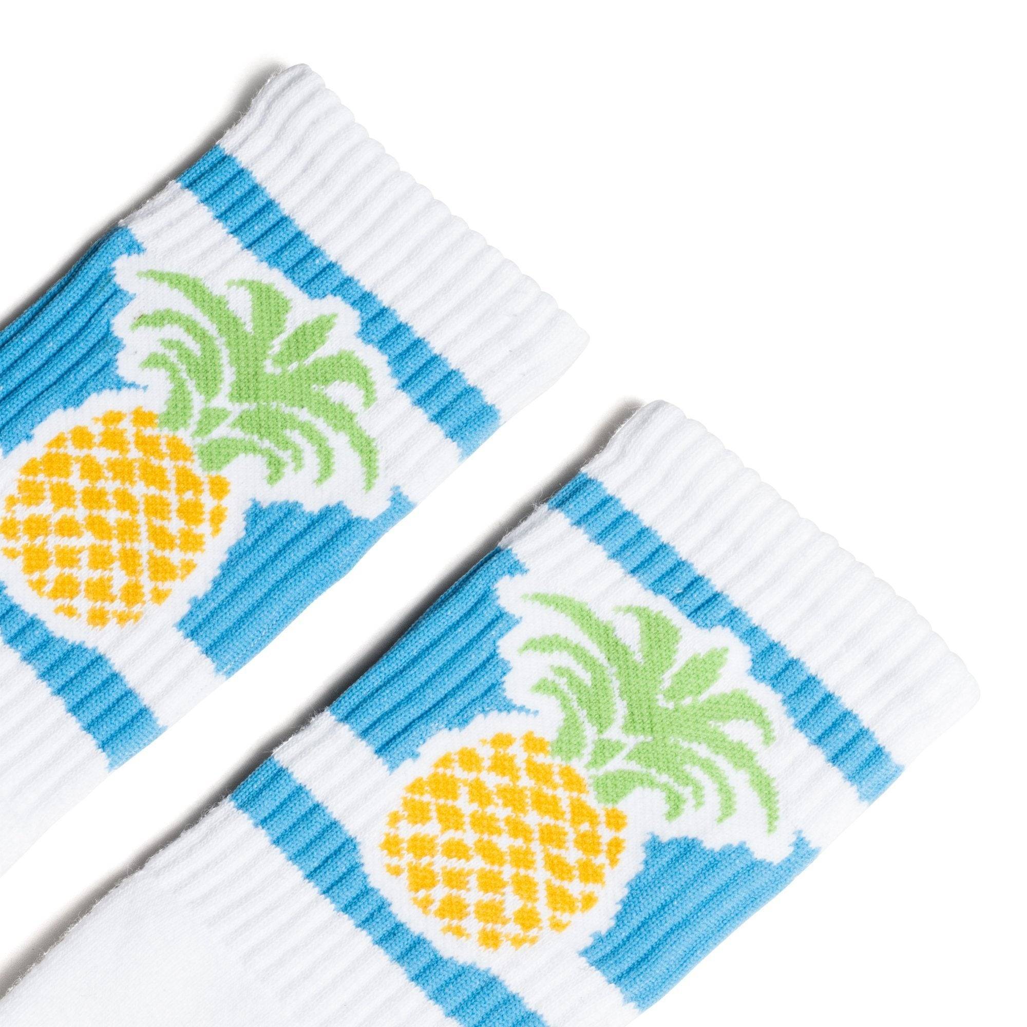 White socks with blue stripes and a pineapple image for men, women and kids.