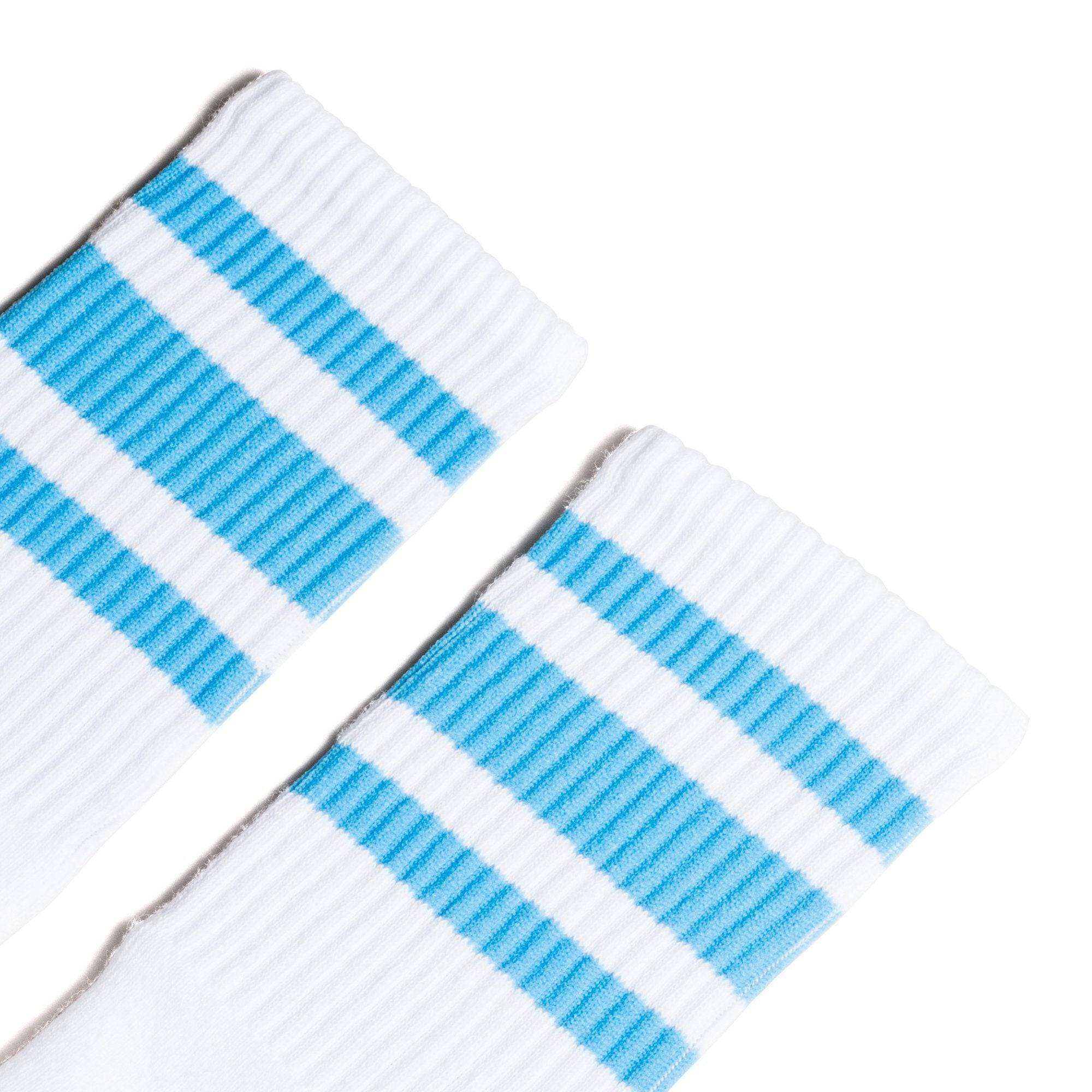 White athletic socks with three Carolina blue stripes. Crew Length Socks for men, women and kids.