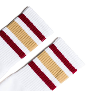 White athletic crew length socks with gold and maroon stripes for men, women and children.
