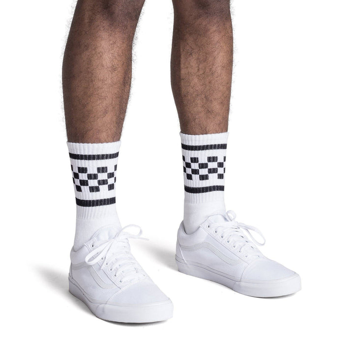 White athletic socks with two black stripes and checkers in between on the Leg. For men, women and kids. Crew Sock Length.