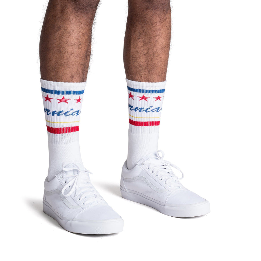 White athletic socks with California text in blue cursive over white and red and blue stripes.