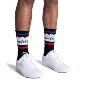 Black athletic socks with California text in blue cursive over white and red and blue stripes. Crew Socks for Men, Women, and Children.