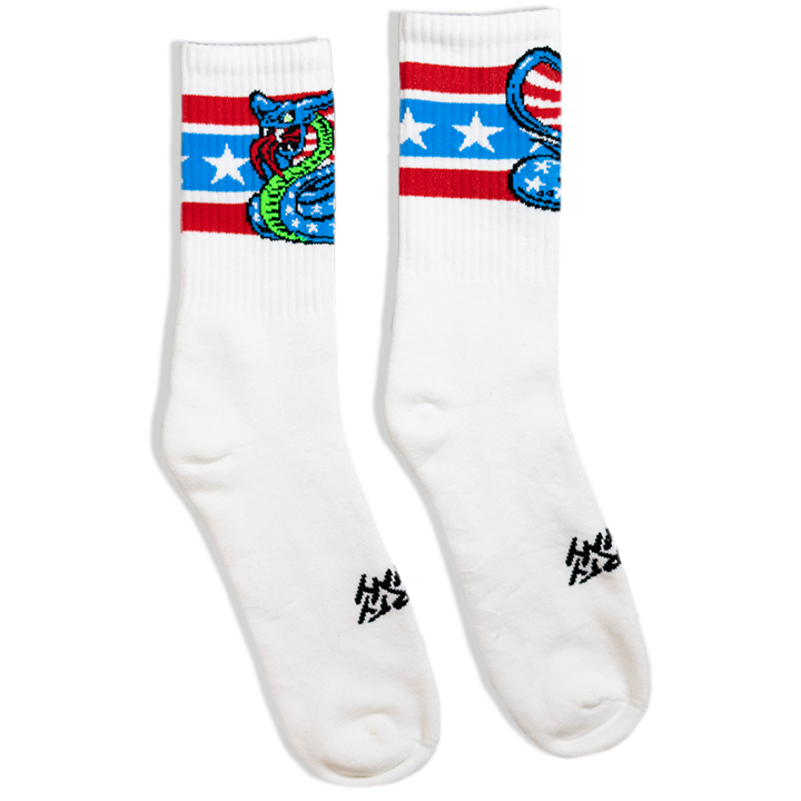 SOCCO x Dirty Donny Cobra Socks. White Crew Socks with three stripes: the top is red, the middle is light blue with white stars, and the bottom is red.  70s style Blue Star Spangles Body with Stripes inside the snake's hood, and an acid green belly. Dirty Donny Logo Signature on the top of the foot.