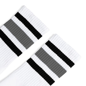 White athletic socks with black and grey stripes on the leg. Made for men, women and children. Crew Sock Length.